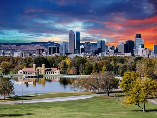 Dramatic autumn sunset reflecting off the lake in Denver City Park.